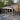 Real glass sunroom attached to a house with patio furniture and outdoor decor.